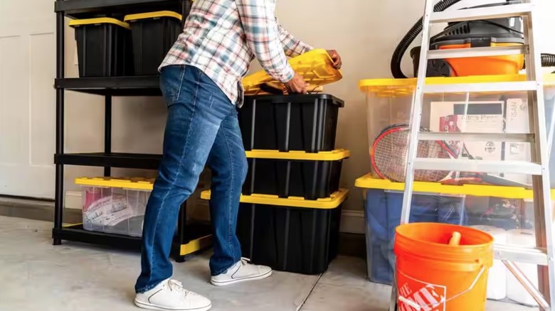 Person putting a lit on an HDX storage crate