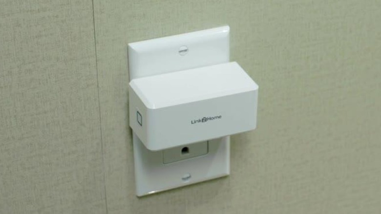 A Link2Home outlet switch plugged into a wall receptacle.