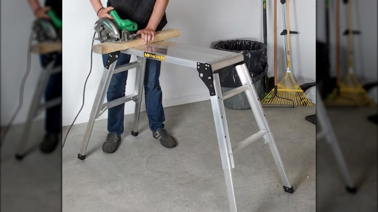 A MetalTech Adjustable Work Platform being used as a sawhorse