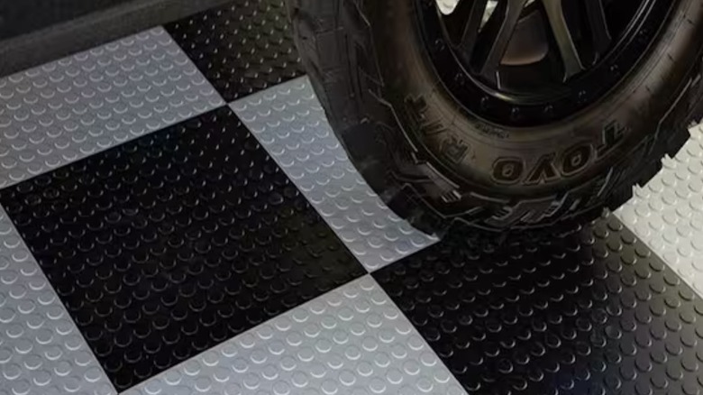 Picture showing car parked on new garage floor tiling