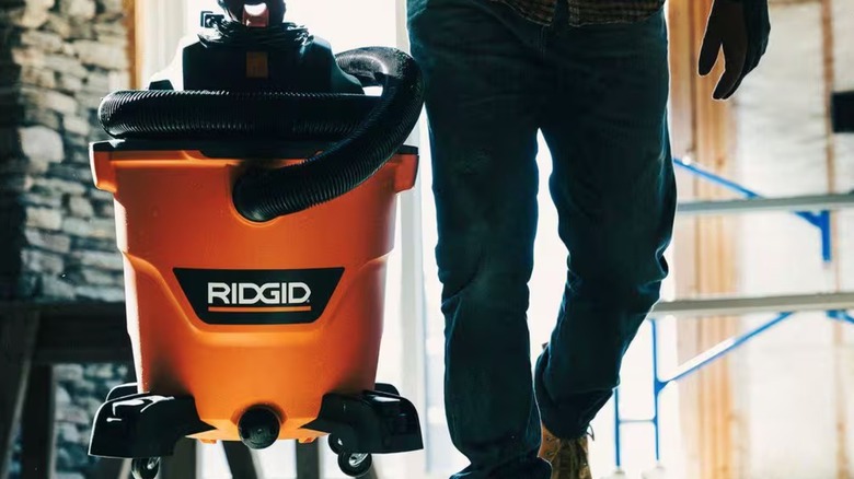 Person carrying a Ridgid Shop Vac