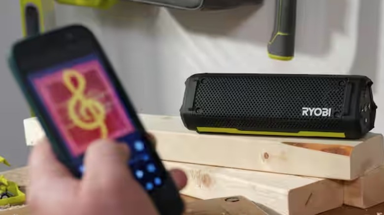Person connecting mobile device to Ryobi speaker