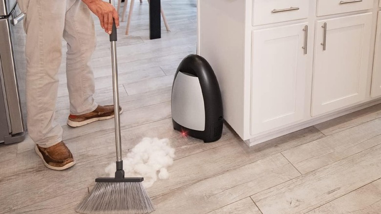 man holding broom using Vacuum Automatic Dustpan
