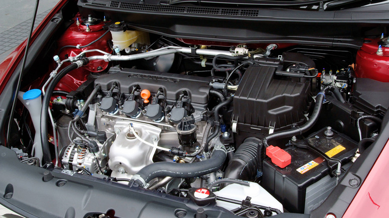 A photograph of the engine bay of a Honda showing off the R20A engine