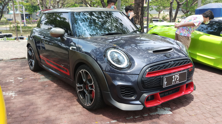 A Mini John Cooper Works GP parked outside.