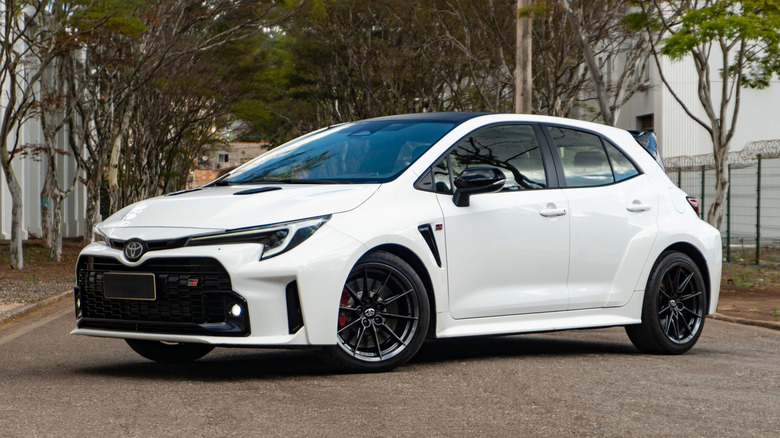 A white GR Toyota Corolla parked outside.