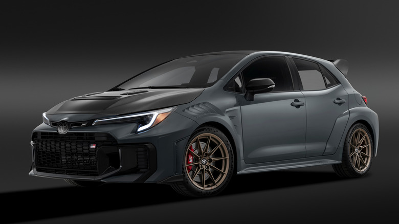 Front 3/4 view of gray 2026 Toyota GR Corolla GRMN parked in studio.