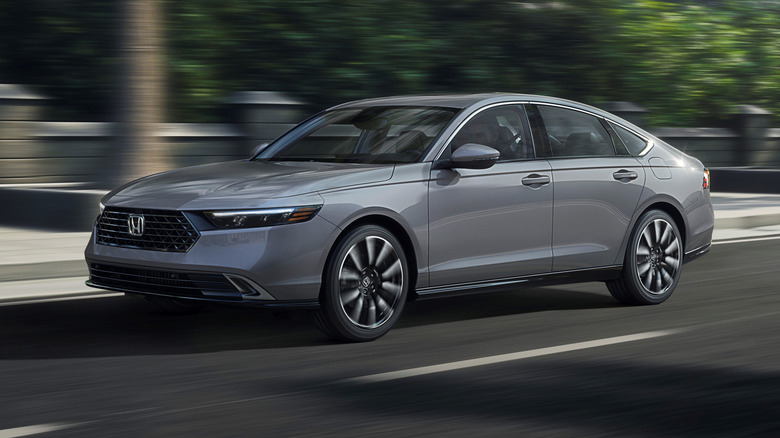 Gray 2026 Honda Accord driving on a city road, front 3/4 view