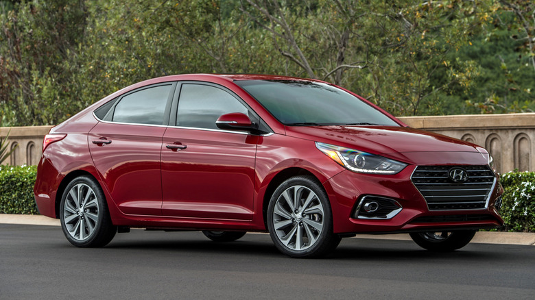Front 3/4 view of red 2022 Hyundai Accent parked.