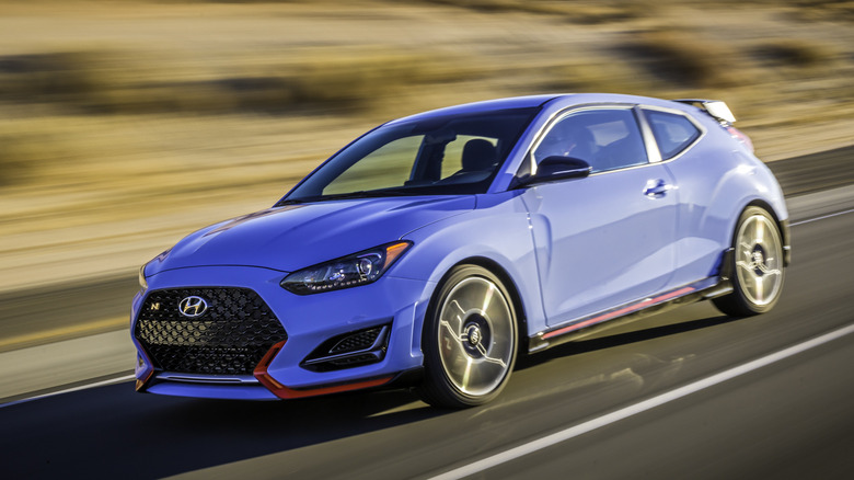 Front 3/4 view of blue Hyundai Veloster N on desert road.
