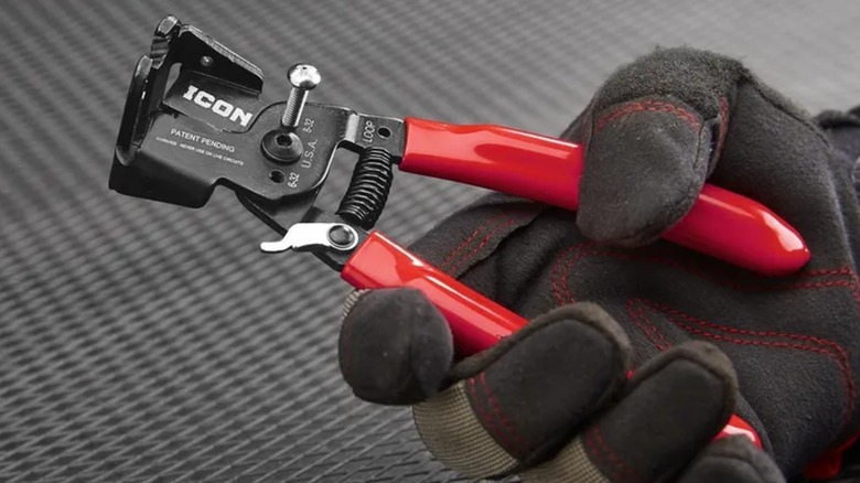 Gloved hand holding Icon wire strippers