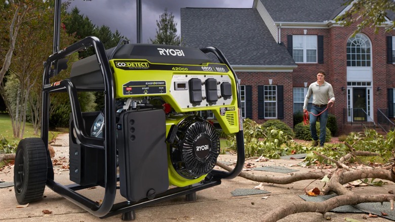 a Ryobi generator with fallen tree branches nearby
