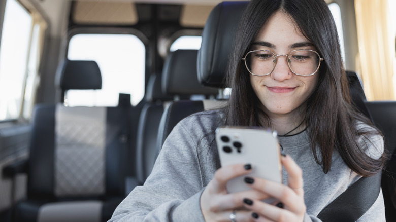 woman using iphone in car