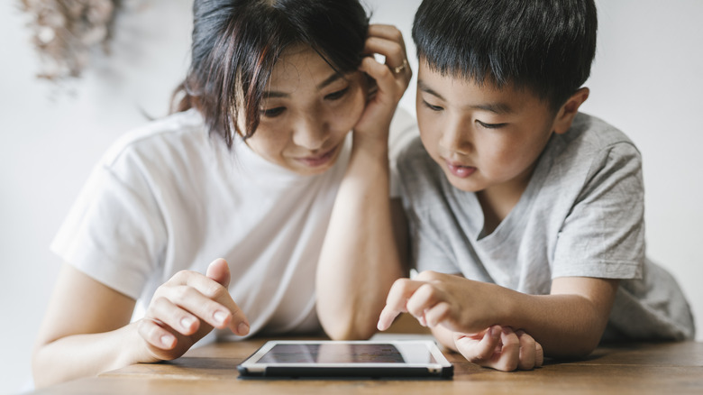 Mother and child using iPad