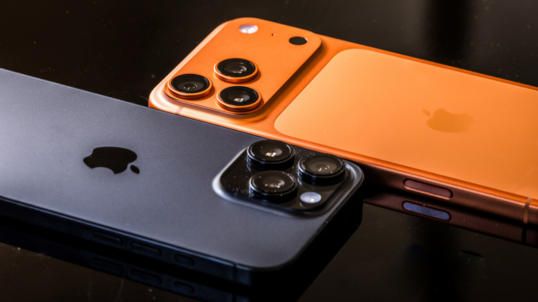 Two iPhones face down on a flat surface