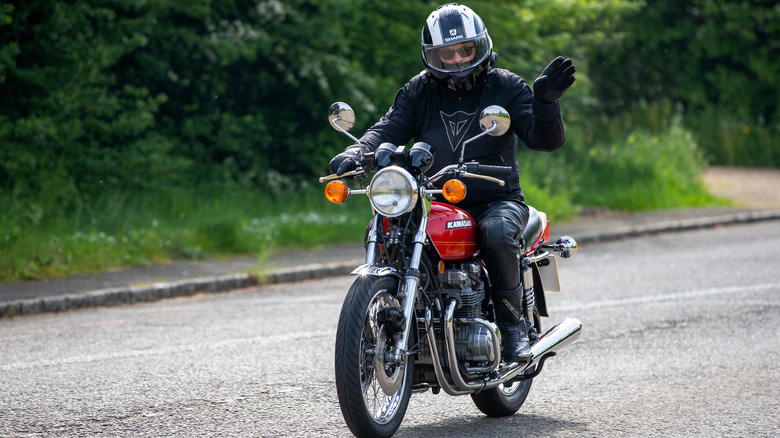 man riding a Kawasaki motorcycle