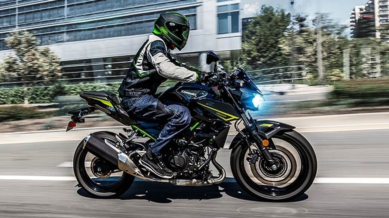 side profile view of the 2023 Kawasaki Z400 riding down the street