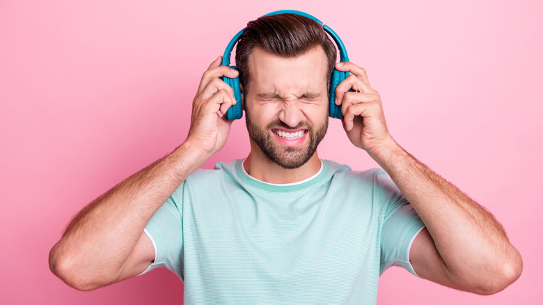 man holding headphones