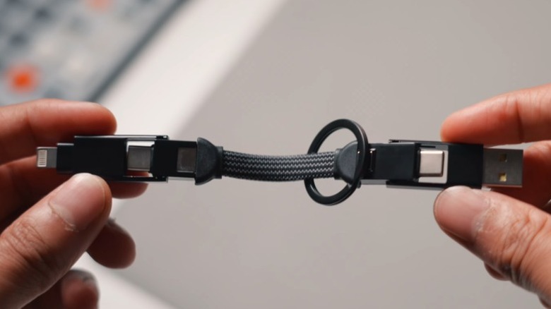 Hands holding the Rolling Square InCharge X 6-in-1 cable