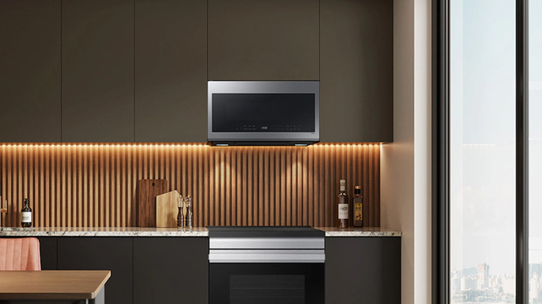 A Samsung microwave on a shelf in an office kitchen