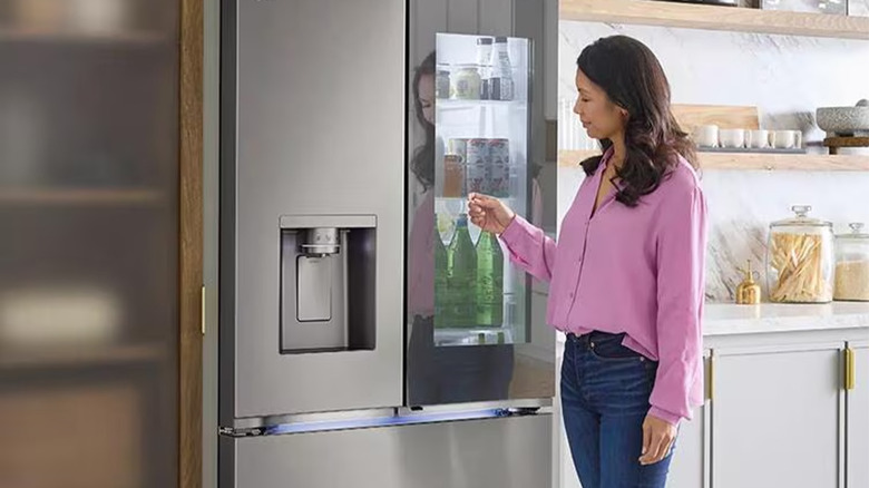A woman using an LG fridge