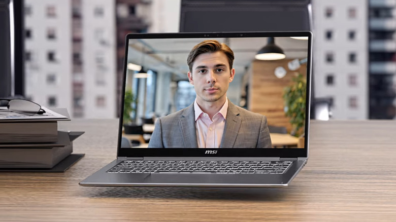 An MSI Prestige 14 Flip AI+ laptop floating above a table, displaying a person in a suit.