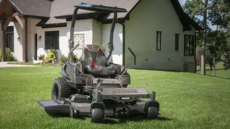 Spartan Defender zero-turn mower on a lawn with a house in the background