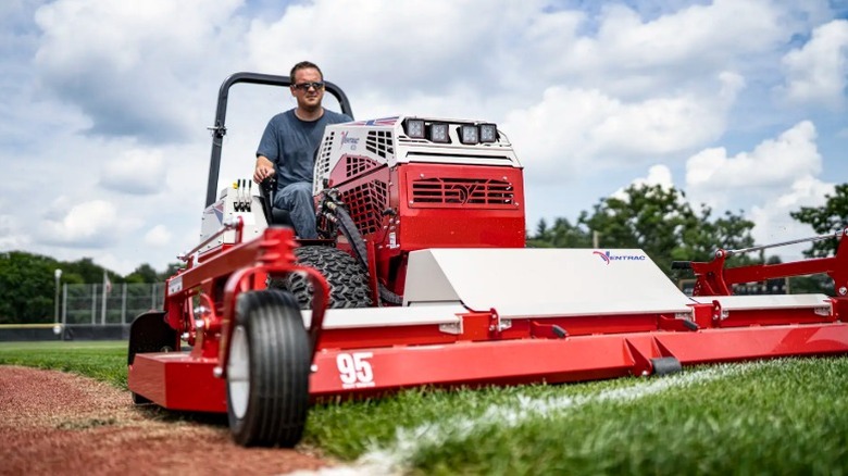 Person using a Ventrac mower with a wide area mower attachment on a baseball field