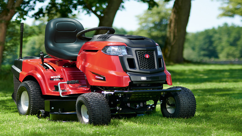 A red and black MTD riding mower.