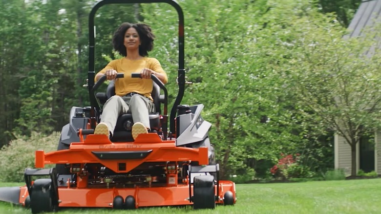 Person cutting grass riding a Bad Boy Mowers Rebel model.
