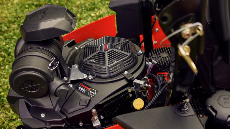A close-up of a Kawasaki engine in an unidentified lawn mower