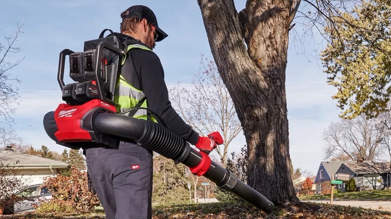 Person using Milwaukee M18 Fuel Dual Battery Backpack Blower