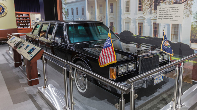 Front 3/4 view of black Lincoln presidential limo parked in museum.