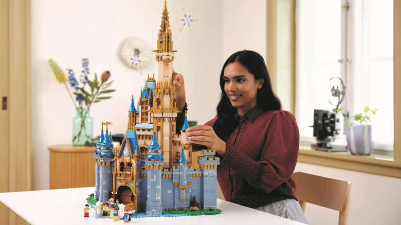 woman building the LEGO Disney Castle