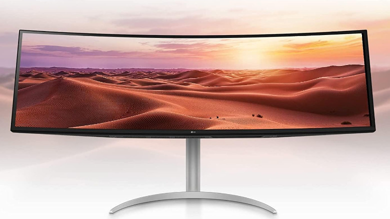 The LG 49WQ95C-W 49-inch 32:9 ultraWide monitors displaying a picture of a desert.