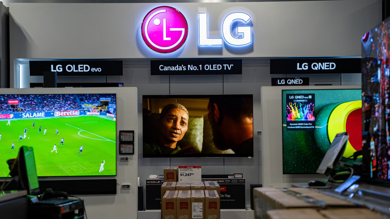 A lineup of LG televisions on display at a store.