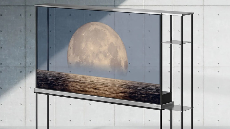 The LG transparent TV OLED T against a concrete wall.