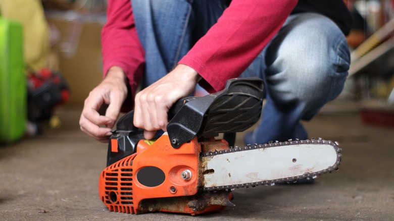 person with small chainsaw
