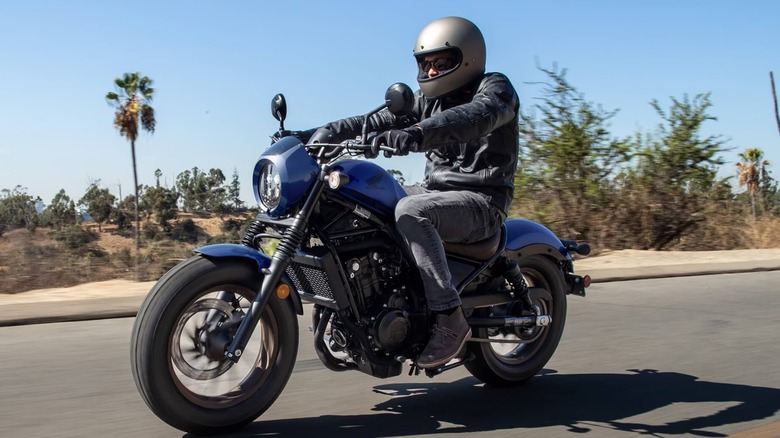 Person riding Honda Rebel 500 through arid climate