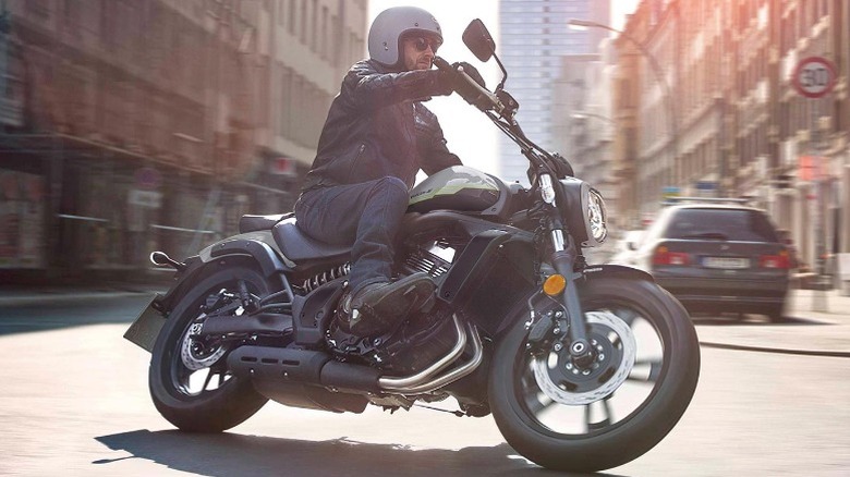 Man riding Kawasaki Vulcan S through city streets