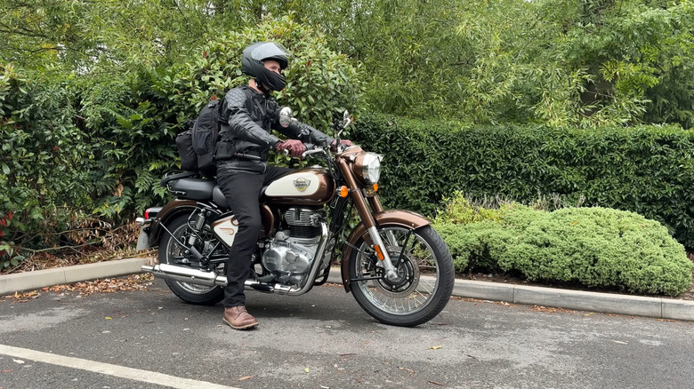 Person on a Royal Enfield Classic 350 about to depart from a parking spot