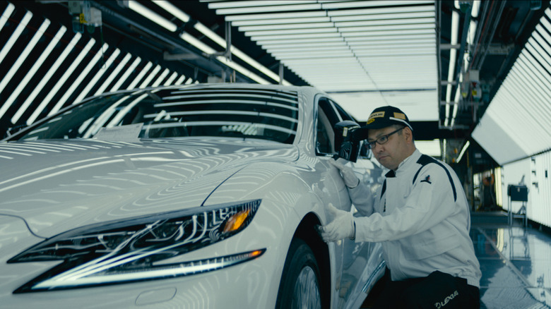 Lexus Takumi master craftsman inspecting a vehicle