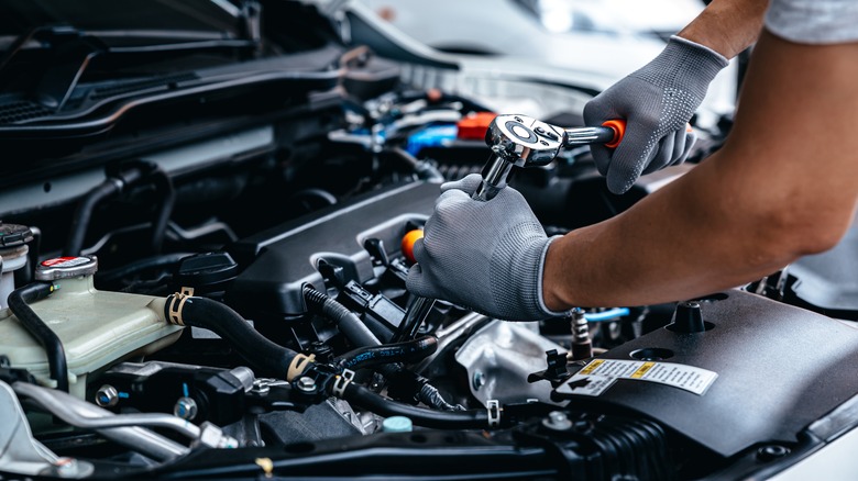 mechanic working vehicle engine