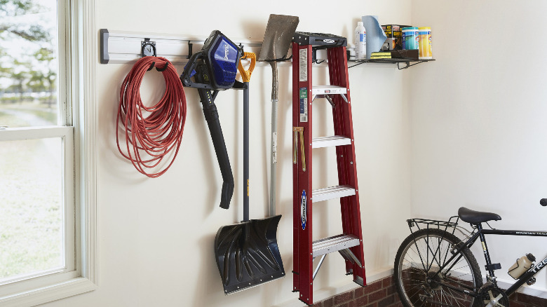 Tools hanging from hooks on a Gladiator GearTrack channel.