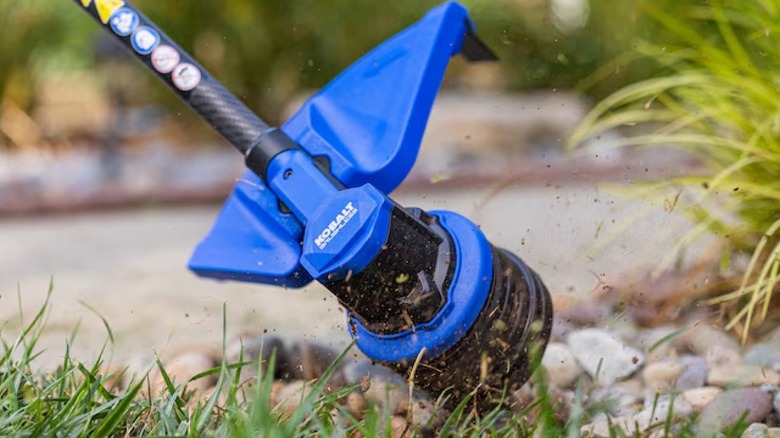 Kobalt 80V 17-inch Straight Shaft String Trimmer head in use