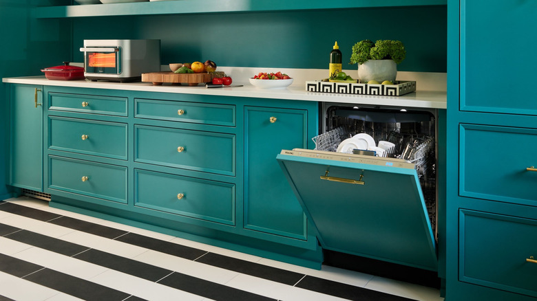 A Viking dishwasher with a custom panel to match the striking turquoise kitchen cabinets