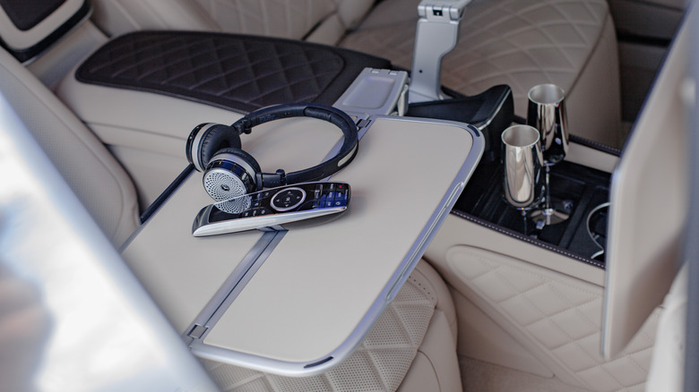 Backseat of a car with a table in between the seats