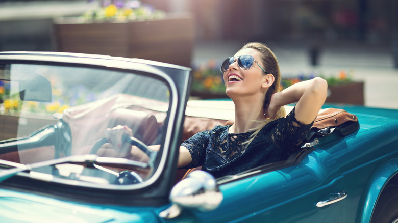 person driving vintage convertible