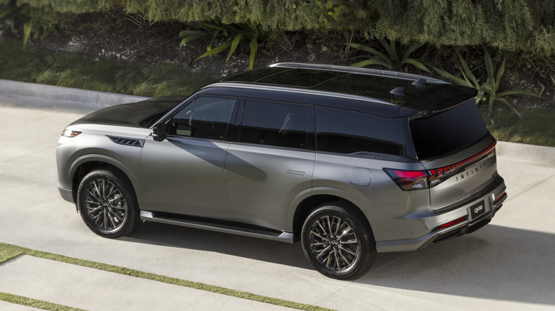2026 Infiniti QX80 in driveway, left-rear 3/4 view from height
