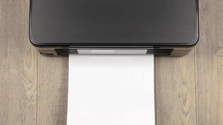 A sheet coming out of a printer.